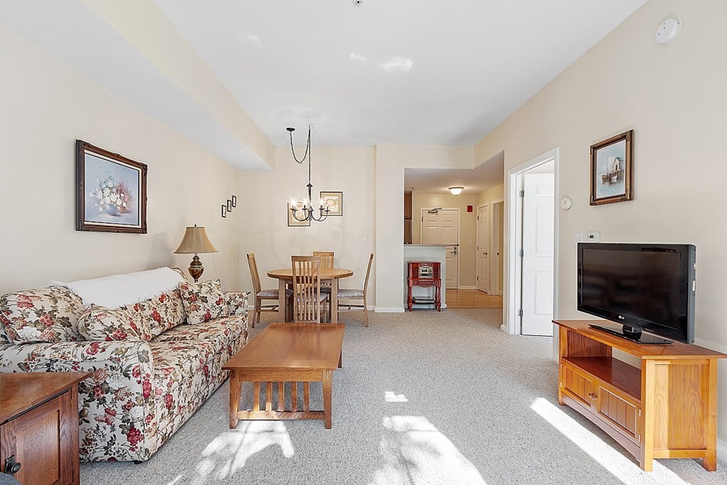 38 Village Road, Unit 310 Middleton, MA 01949 - Photo 5 of 18 a living room with furniture and a flat screen tv