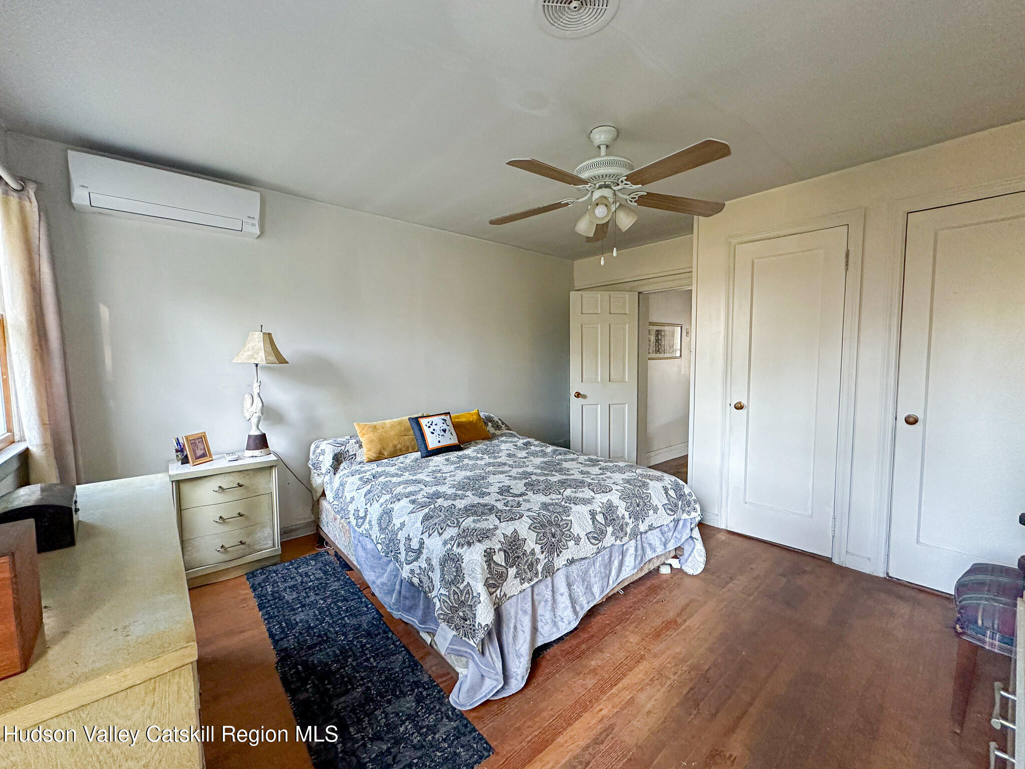 91 Drake Hill Road Greenville, NY 12431 - Photo 11 of 28 a bedroom with a bed and a chandelier