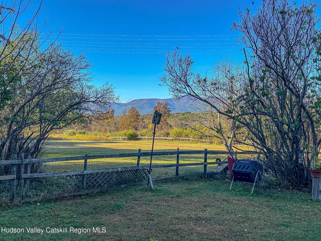a view of backyard with swimming pool and outdoor seating