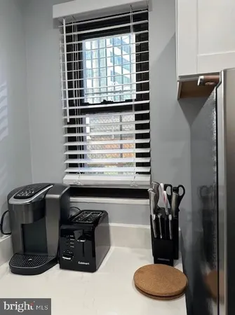 a bathroom with a sink a toilet and a window