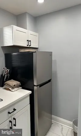 a kitchen with a sink and a refrigerator
