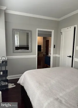 a bedroom with a bed and a mirror