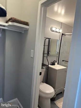 a bathroom with a sink a toilet and mirror