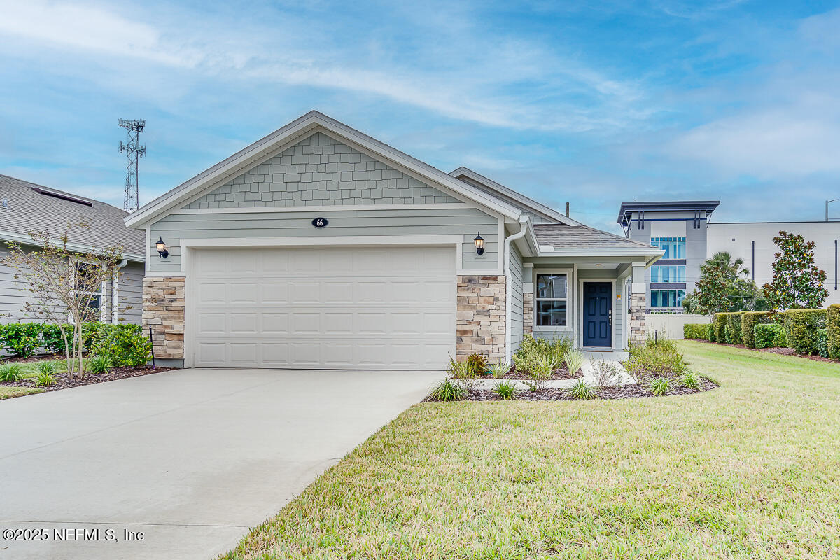 a front view of house with yard garage and green space