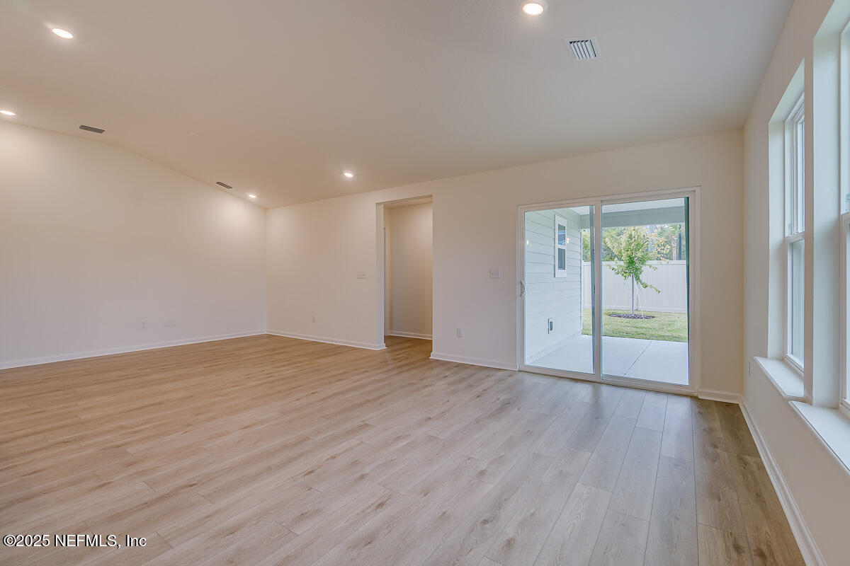 66 Stonecrest Drive St. Johns, FL 32259 - Photo 6 of 22 an empty room with wooden floor and windows