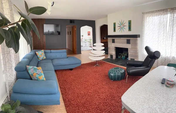 a living room with furniture and a fireplace