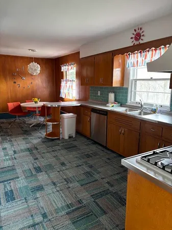a kitchen with a stove a sink and a refrigerator
