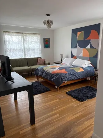 a bedroom with two beds and a window