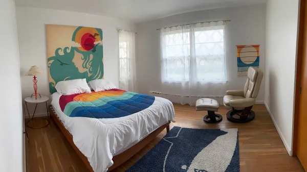 a bedroom with a bed and glass window