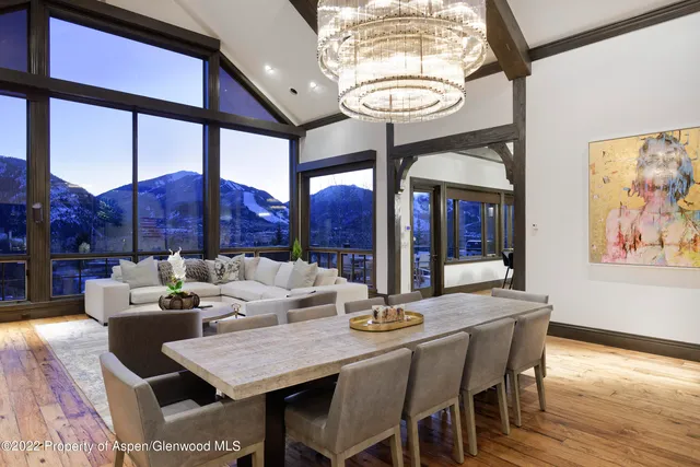 a view of a dining room with furniture wooden floor and chandelier