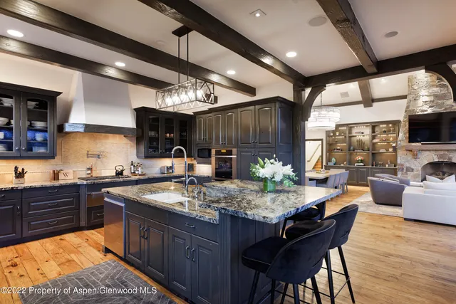 a kitchen with stainless steel appliances granite countertop a sink stove and wooden cabinets