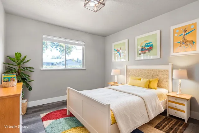 a bedroom with bed and a window