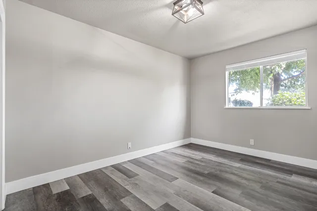 a view of a room with wooden floor and windows