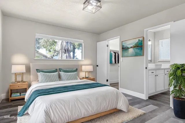 a bedroom with a bed and a chandelier