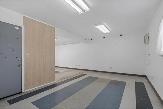 a view of a house with wooden floor next to a yard