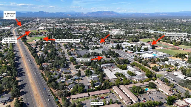 an aerial view of a house with a yard and seating space