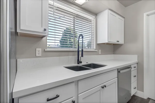 a kitchen with a sink and cabinets