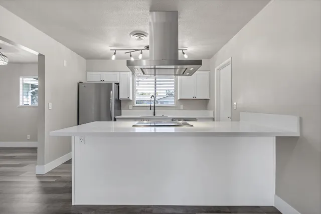 a kitchen with refrigerator and window