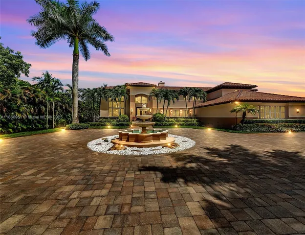 a view of a white house with a yard in front of it