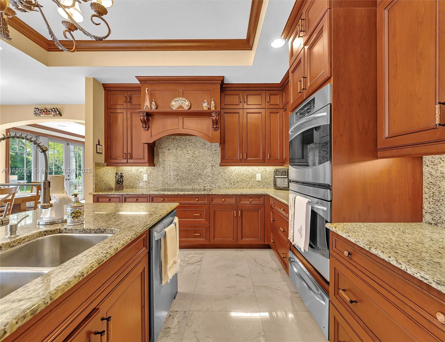 13425 Southwest 37th Place Davie, FL 33330 - Photo 27 of 100 a kitchen with stainless steel appliances granite countertop a sink and cabinets