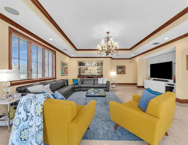 a living room with furniture and a floor to ceiling window