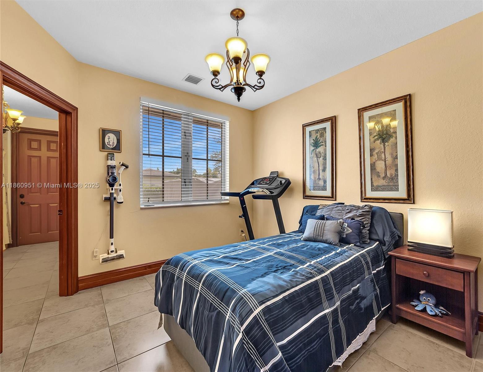 13425 Southwest 37th Place Davie, FL 33330 - Photo 56 of 100 a bed room with a bed and a chandelier