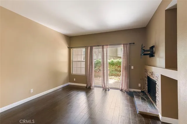 wooden floor in an empty room with a fireplace