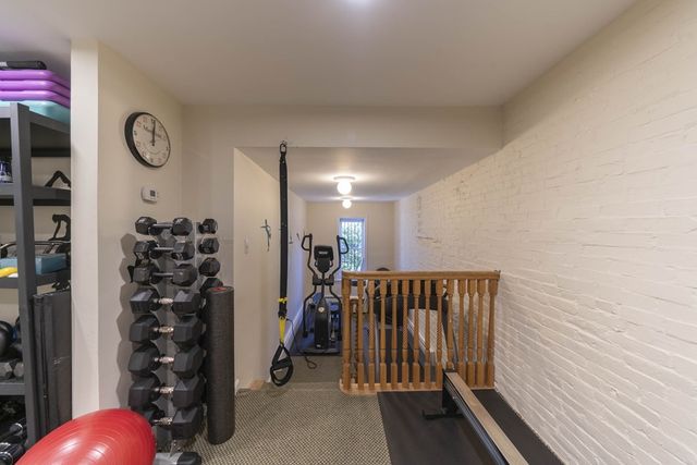 a view of a livingroom with wooden floor and stairs