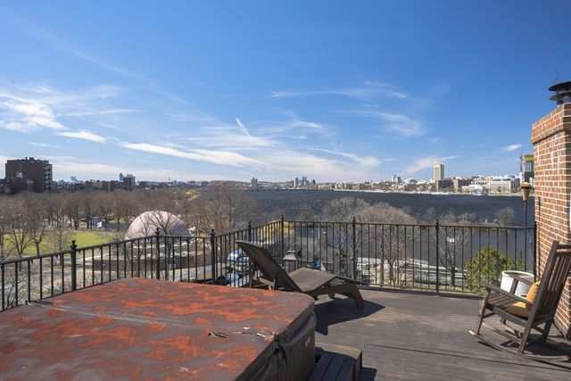 a view of a balcony with wooden floor and iron stairs