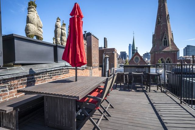 a view of a balcony with furniture and wooden floor