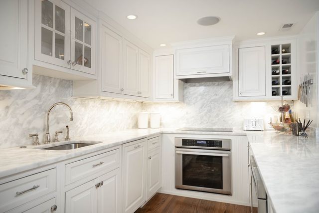 a kitchen with cabinets stainless steel appliances and a sink