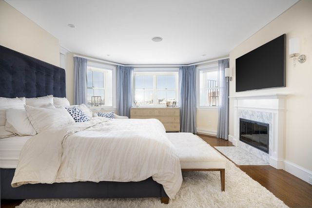 a bedroom with a large bed and a flat screen tv