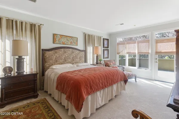 a bedroom with a bed and a large window