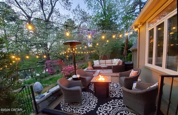 a view of a patio with couches chairs and potted plants
