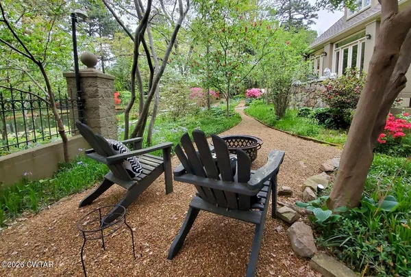 a view of a chairs and table in the patio