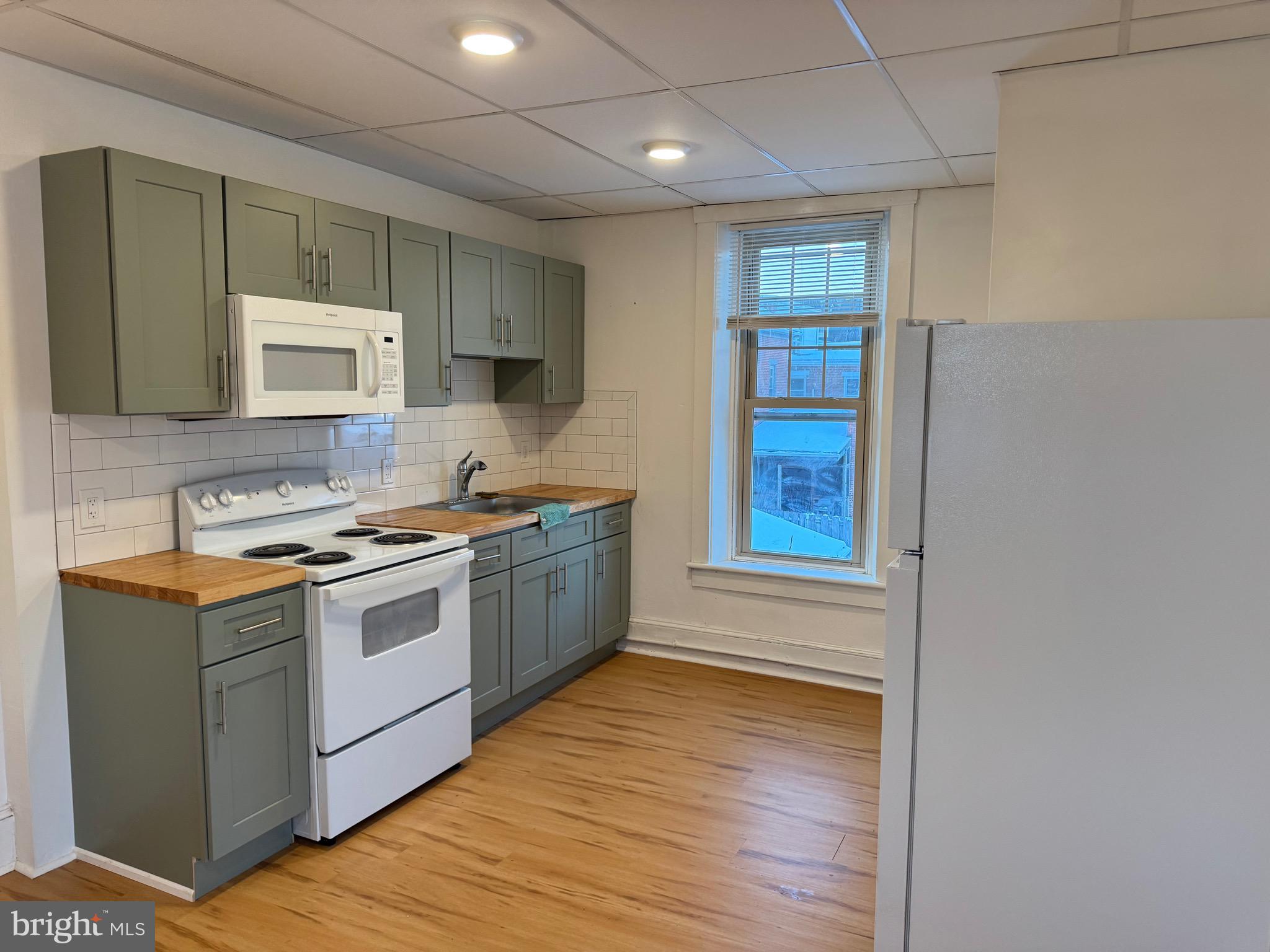 171 South Charlotte Street, Unit 5 Manheim, PA 17545 - Photo 1 of 5 a kitchen with stainless steel appliances granite countertop a stove a sink and a microwave