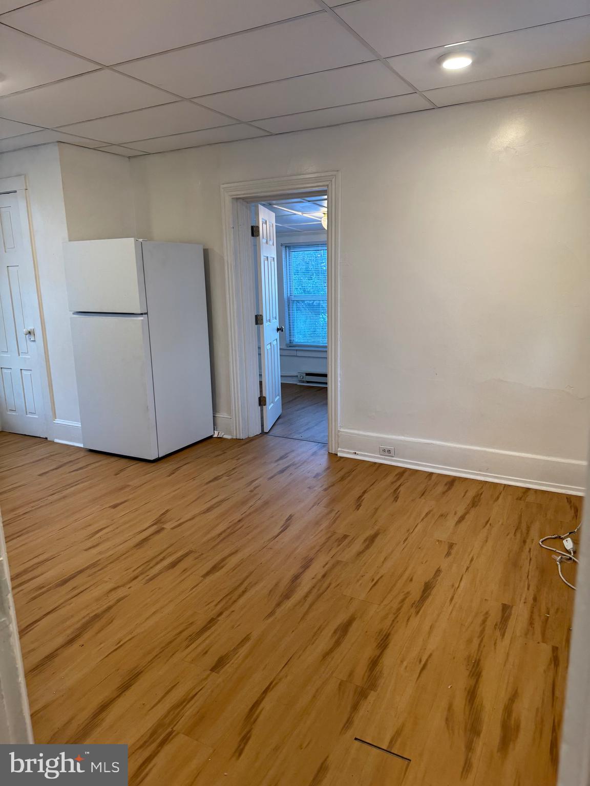 171 South Charlotte Street, Unit 5 Manheim, PA 17545 - Photo 2 of 5 a view of an empty room with wooden floor and cabinet