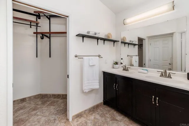 a bathroom with a sink tub shower and a mirror
