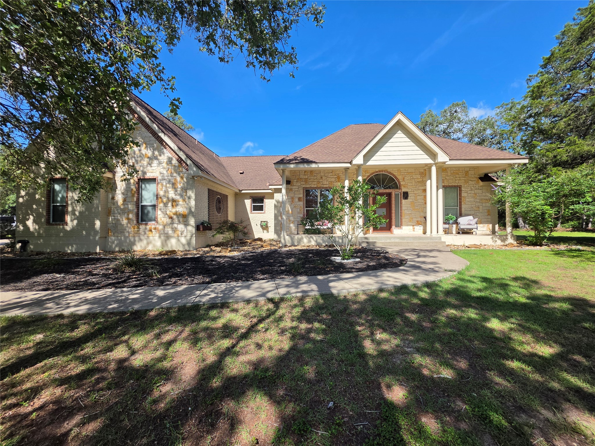 330 Arbors Circle Elgin, TX 78621 - Photo 4 of 37 A graceful stone facade and mature landscaping welcome you home to this charming residence.