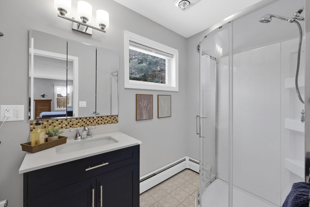 14 Bridle Path Broad Brook, CT 06016 - Photo 21 of 37 a bathroom with a sink mirror and a shower