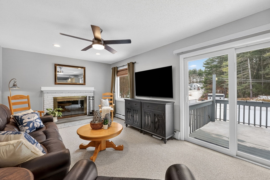 14 Bridle Path Broad Brook, CT 06016 - Photo 4 of 37 a living room with furniture a fireplace and a flat screen tv