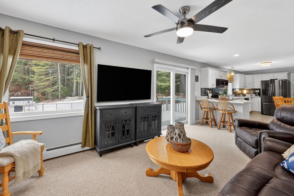 14 Bridle Path Broad Brook, CT 06016 - Photo 5 of 37 a living room with furniture a flat screen tv and a large window