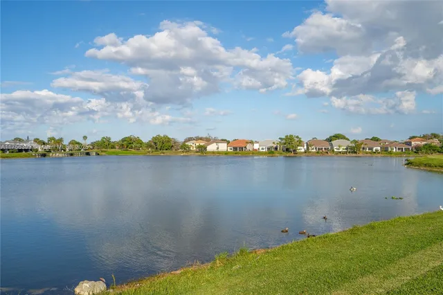 a view of a lake with houses in the background