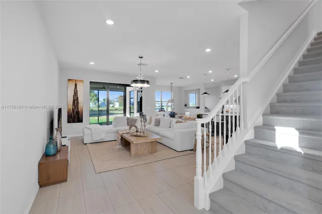 a living room with lots of furniture and a chandelier