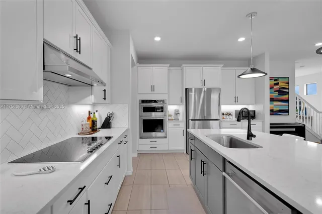 a kitchen with cabinets a sink and appliances