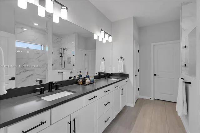 a bathroom with double sink and a mirror