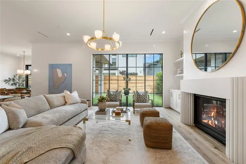 a kitchen with a stove a sink a center island and windows