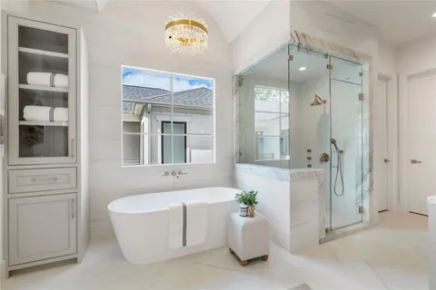 a view of a hallway with wooden floor and a livingroom