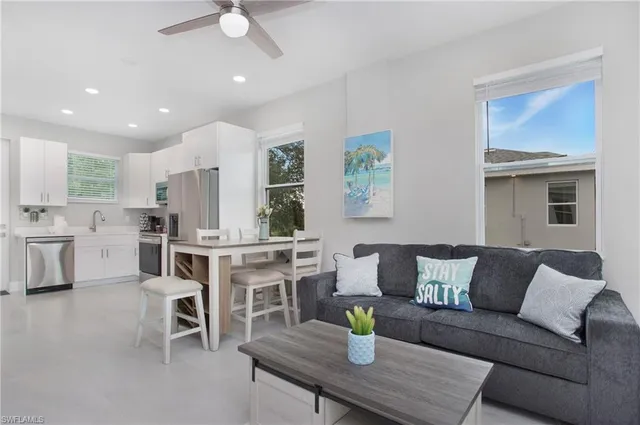 a living room with furniture and kitchen view
