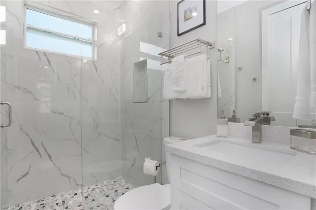 a bathroom with a sink toilet and shower